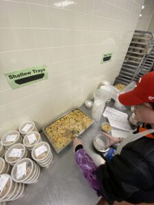 Volunteer Adam works in meal packaging in Boston